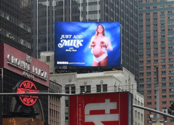 Times Square billboard featuring a pregnant woman covering her breasts with two oatmeal coo<em></em>kies.
