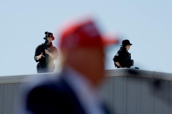 Secret Service agents and local law enforcement agents stand in position on the roof nearby as Republican presidential candidate former President Do<em></em>nald Trump speaks at a campaign rallat the Aero Center Wilmington on September 21, 2024 in Wilmington, North Carolina.