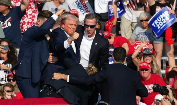 Republican candidate Do<em></em>nald Trump is seen with blood on his face surrounded by secret service agents as he is taken off the stage at a campaign event at Butler Farm Show Inc. in Butler, Pennsylvania, July 13, 2024.