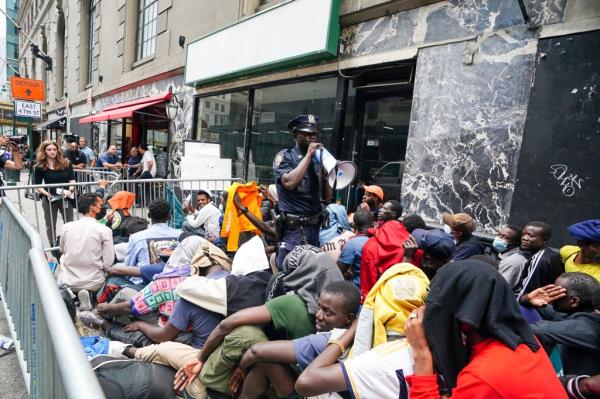 Migrants outside the Roosevelt Hotel.