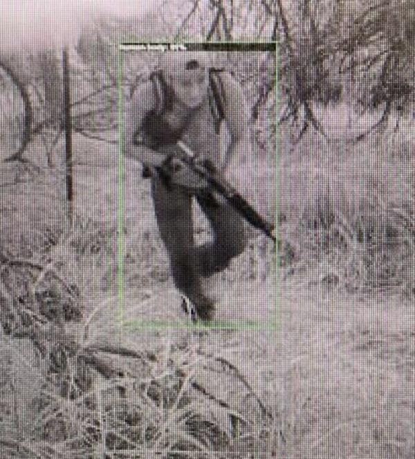 A suspected cartel member is seen carrying a weapon through the island.