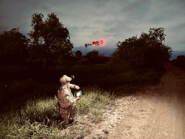 A member of the Texas Department of Public Safety is seen deploying a drone.