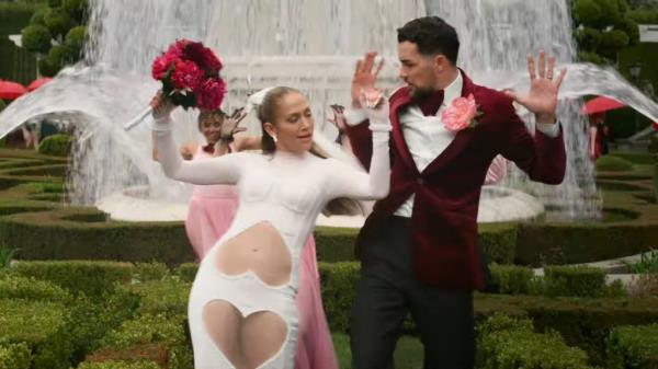 Jennifer Lopez dressed as a bride with a groom. 
