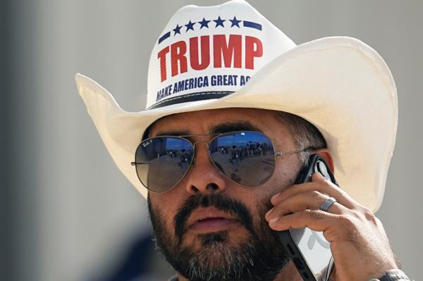 A Trump supporter waits for his arrival at the South Texas Internatio<em></em>nal Airport on Sunday.