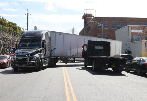 A truck tries to maneuver o<em></em>nto Review Avenue.