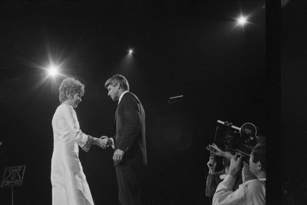 Los Angeles:Actress Shirley MacLaine introduces Sen. Robert Kennedy at a mass Hollywood-style rally and show at the Sports Arena 5/24. 