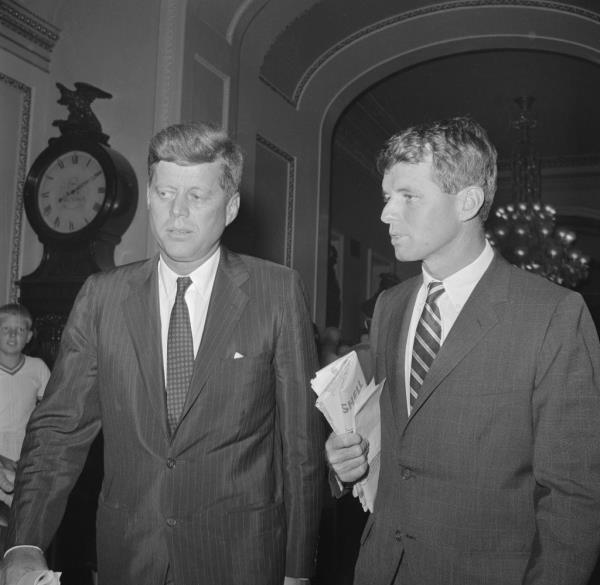 Senator John Kennedy (Mass.)(left), democratic Presidential nominee, co<em></em>nfers with his brother Robert while enroute to the Senate floor to vote on the Medical care for the aged bills. 