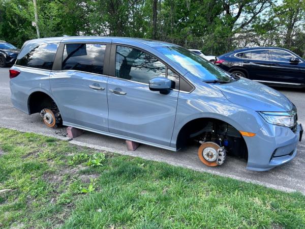 Car on blocks with Tires removed or stolen parked along Grand Central Service Road, Queens, New York.