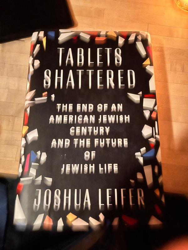 A hardcover book with a black cover and white font.
