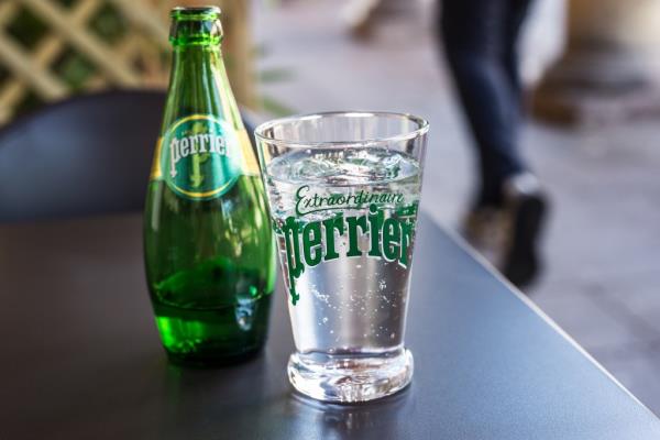 Closeup of a glass of Perrier carbo<em></em>nated mineral water on a restaurant terrace in Mulhouse, France, taken on 6th July 2020