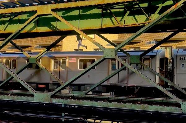 A heart-pounding clip taken Thursday by a co<em></em>ncerned New Yorker near the 111th Street station in Corona shows someone precariously jogging along the top of an elevated subway car. 