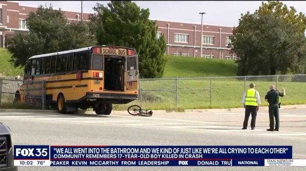 A school bus and a damaged bike are seen outside Lake Minneola High School Monday