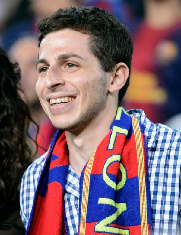 Israeli soldier Gilad Shalit, right, smiles during a Spanish La Liga soccer match between FC Barcelona and Real Madrid at the Camp Nou stadium in Barcelona, Spain, Oct. 7, 2012
