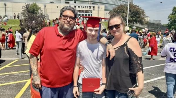 John Procter VI with his parents at his high school graduation. 