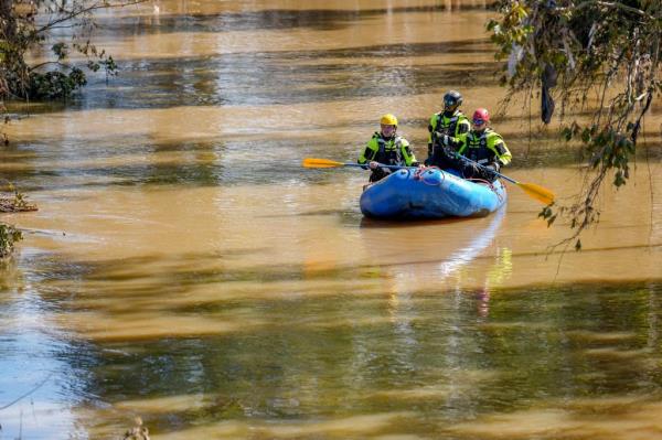 First respo<em></em>nders paddling in a boat up the Swannanoa River in Asheville, NC, during flood aftermath due to remnants of Hurricane Helene.