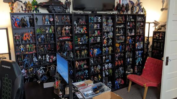 A large book shelf displaying Dan Larson's toy collection in his home.