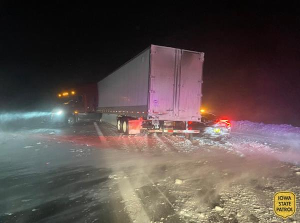 A semi truck crashed into a state trooper car.