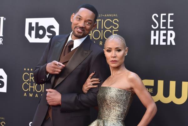 Jada Pinkett Smith and Will Smith smiling together. 