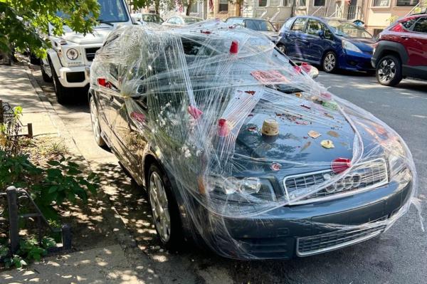 A photo of the car, covered in trash and food.