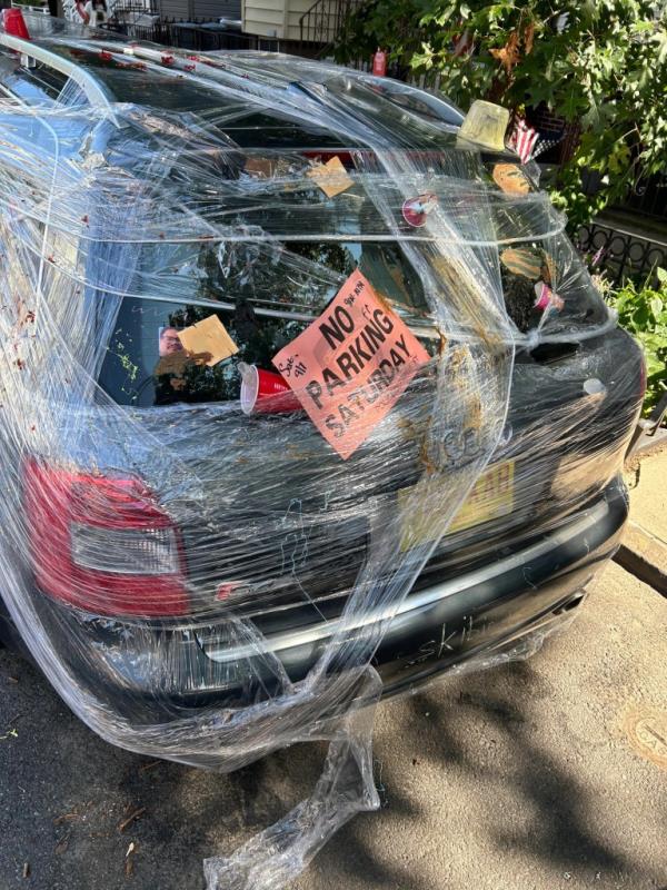 A photo of the messy car, with the No Parking sign attached.
