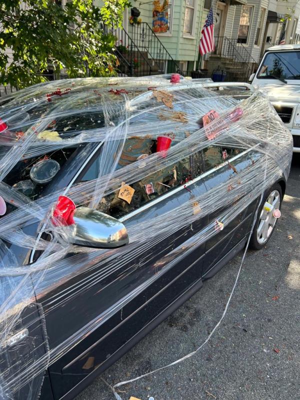A photo of the car, covered in trash and food.
