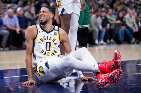 Pacers guard Tyrese Haliburton (0) reacts after being injured during the first half of an NBA basketball game against the Boston Celtics