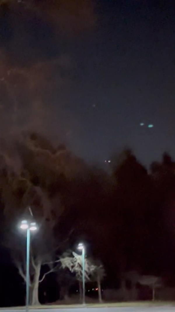 A photo of a drone flying at night. 
