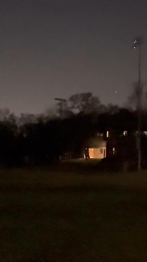 A photo of a drone flying at night. 