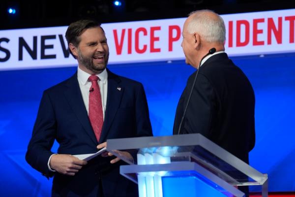 Republican vice presidential nominee JD Vance and Democratic vice presidential candidate Tim Walz sharing a friendly moment after a debate in 2024