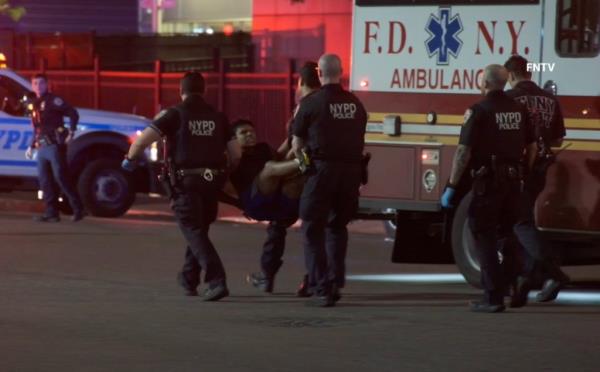 The 19-year-old suspect in the shooting seen being carried away by police.