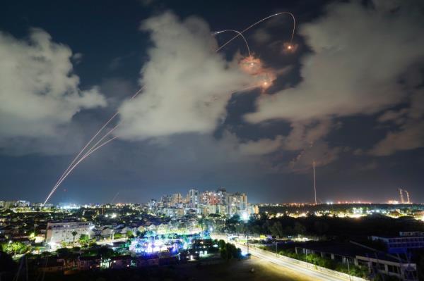Rockets from the Israeli Iron Dome air defense system maneuver to intercept a rocket fired from the Gaza Strip, in Ashkelon, Israel, Thursday, Oct. 19, 2023.