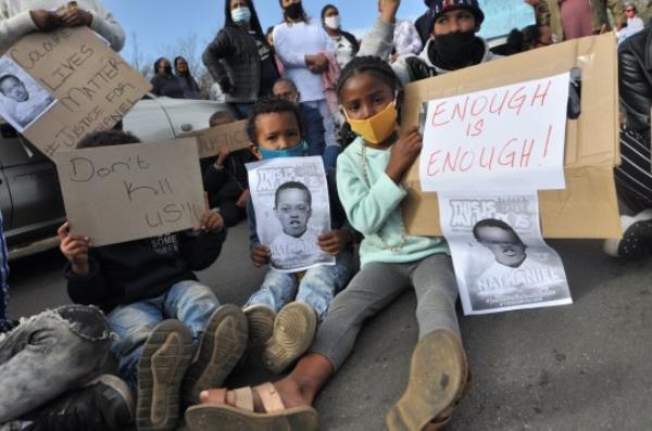 Community members demo<em></em>nstrate during a sit down peaceful protest against the killing of 16 year old Nathaniel Julius at Eldorado Park Police Station on August 30, 2020 in Eldorado Park, South Africa. 
