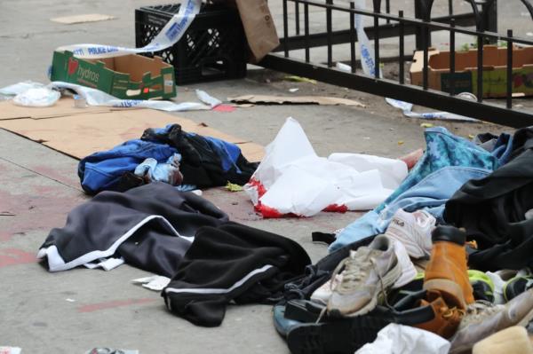 Blood stains remained on an East Village sidewalk a day after the fatal stabbing.