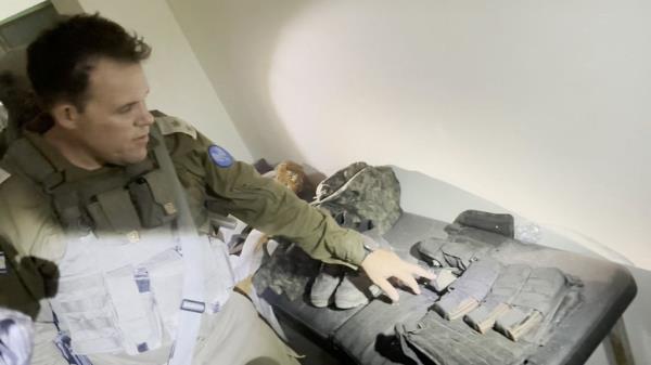 An Israeli officer points at equipment that he says was discovered in a bag at the Al Shifa hospital