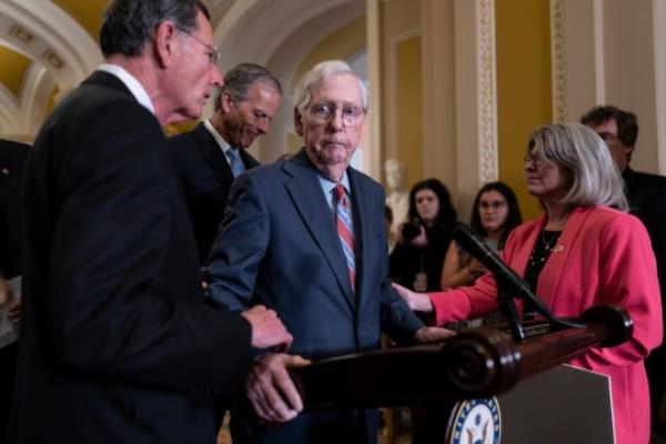 Senate Minority Leader Mitch McCo<em></em>nnell (center) froze at the micropho<em></em>nes as he arrived for a news co<em></em>nference at the Capitol on July 26