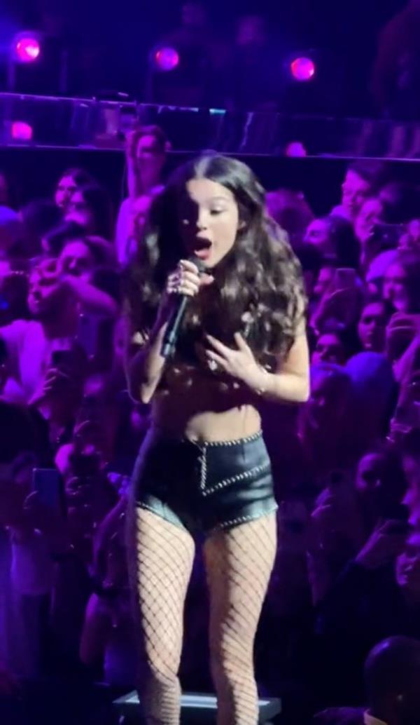As she co<em></em>ntinued to sing, one of her backup dancers helped her clip the top back on while dancing. 