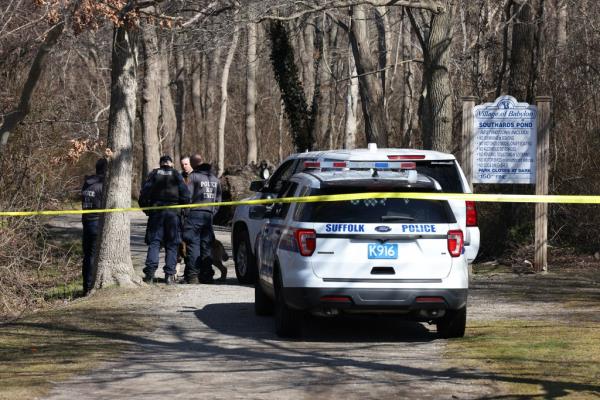 The Suffolk County police K-9 unit searches the Southards Pond Park in Babylon, NY wher<em></em>e body parts were found.