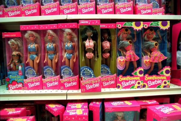 FILE - Barbie dolls line the shelves at a toy store in Torrance, Calif., Dec. 14, 1995. The color pink has long been associated with the Barbie brand ?￠ she even has her own Pantone color. But even though Barbie was first released in 1959, Mattel didn't star featuring predominantly pink packaging until the 1970s, said Kim Culmone, Mattel's senior vice president and global head of Barbie and fashion dolls design. ()