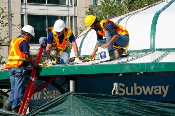Workers apply paint