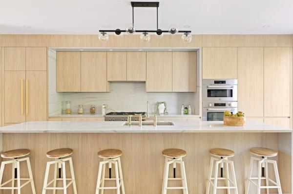 The roomy kitchen has counter seating and leads to room for a dining space.