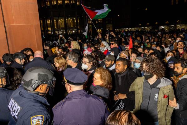 NYPD officers detain pro-Palestinian students and protesters who had set up an encampment on the campus of New York University 