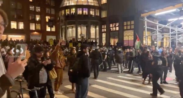 TOPSHOT - NYPD officers detain pro-Palestinian students and protesters who had set up an encampment on the campus of New York University 