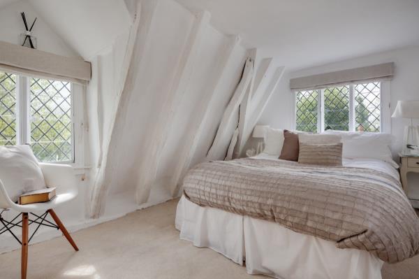 Master bedroom decorated in neutral colors like beige and white