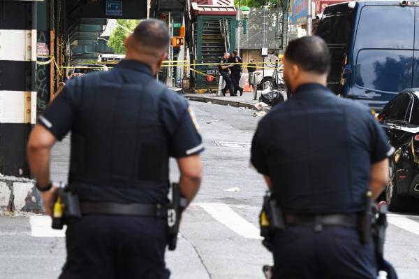  The NYPD co<em></em>ntinue to lock down the block between W 206 and W 207th Streets along 10th Ave, in NYC, after a shooting occurred early this morning involving multiple victims. 