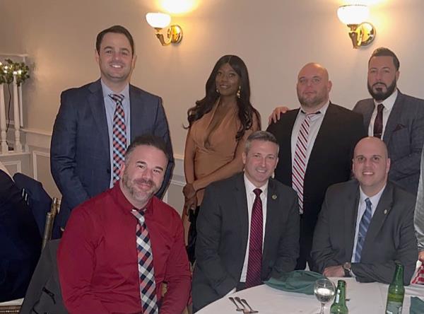 Annaruth Legarge poses with detectives from the 123rd Precinct