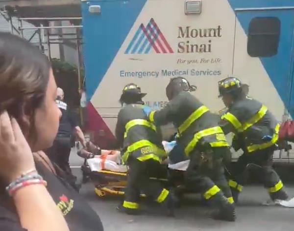 EMS workers rushing the victim into the ambulance. 