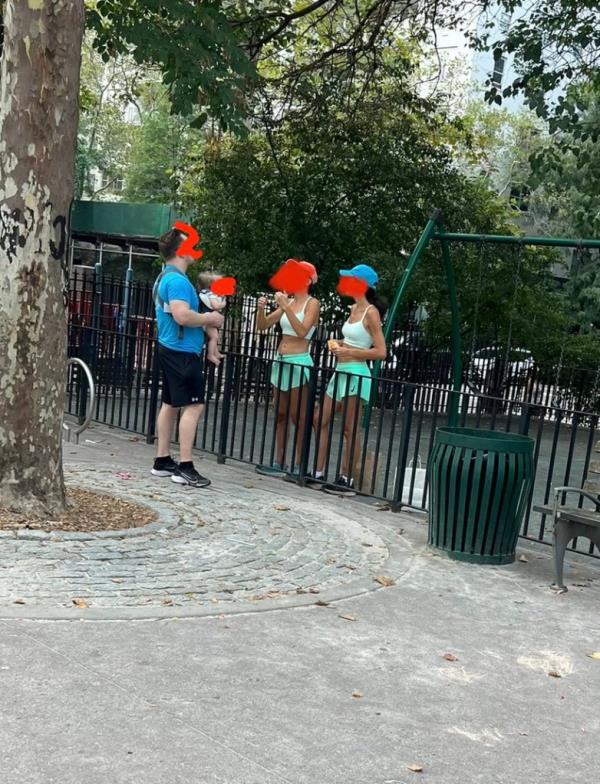 Twins Gabriela Mordocea and Mihaela Mordocea havin<em></em>g an altercations with a man holding a baby in a carrier in John Jay park. All parties have blurred faces. 