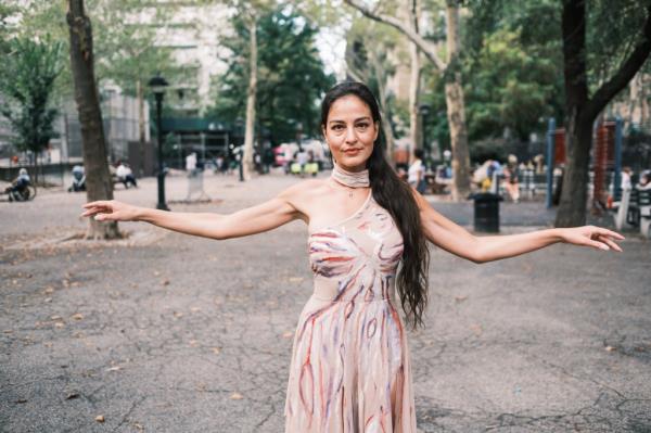 Gabriela Mordocea dancing in the a park. 