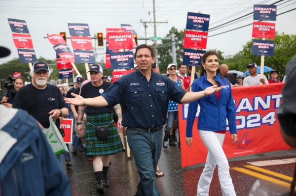 Republican presidential candidate and Florida Gov. Ron DeSantis and his wife Casey, walk in the July 4th parade, Tuesday, July 4, 2023, in Merrimack, N.H.