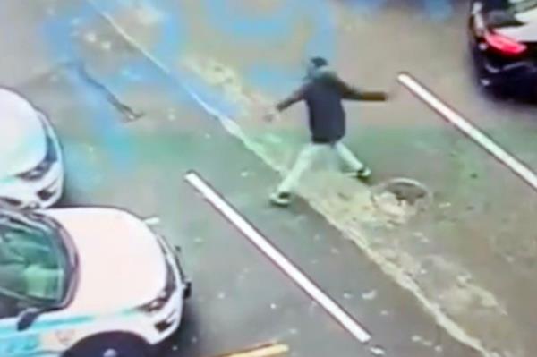 A photo of the suspect hurling a rock through the station house window.